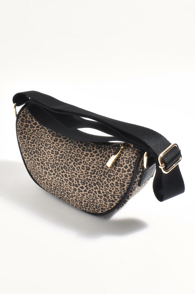 A leopard print faux leather saddle crossbody bag with a black strap and plated metal hardware.