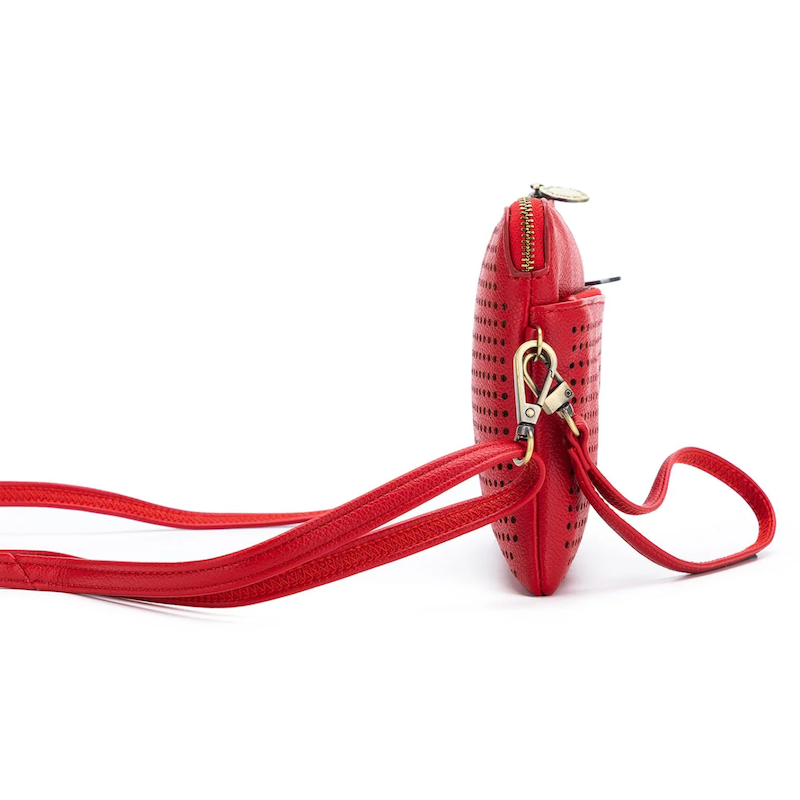 A red Nina crossbody clutch with a perforated front and a solid red back, displayed on a white background.
