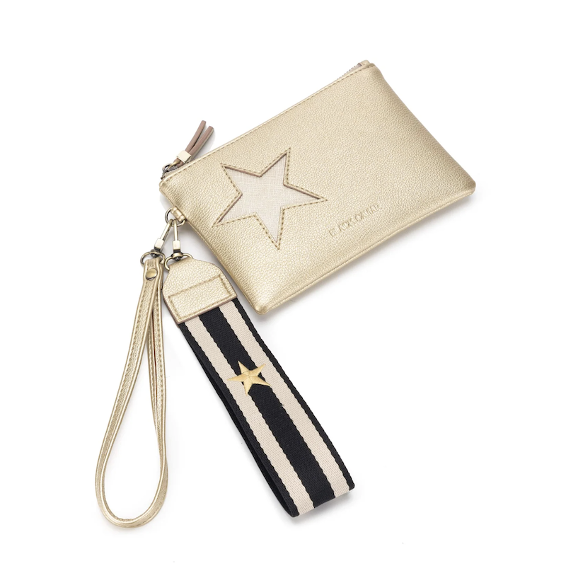 A gold-colored Stellina pouch with a metallic star detail on the front, gold hardware, and a black and white cotton wristlet strap.
