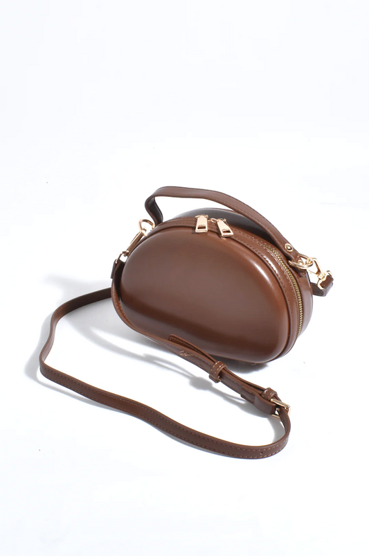 Brown leather crossbody bag with gold accents on a white background