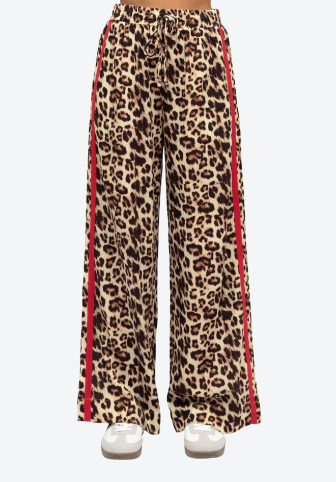 Leopard print pants with red stripes on a white background