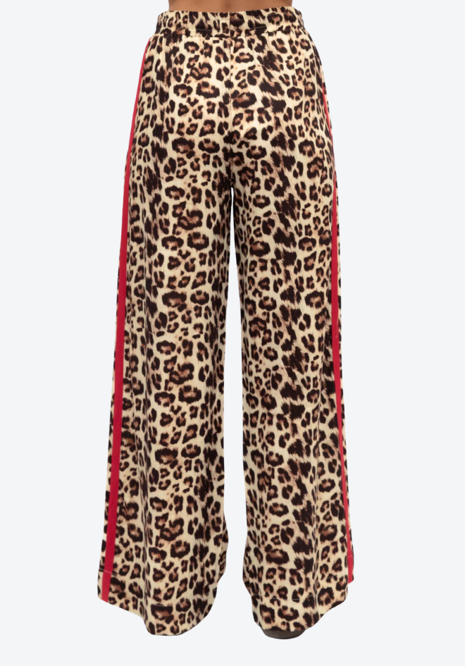 Leopard print pants with red trim on a white background