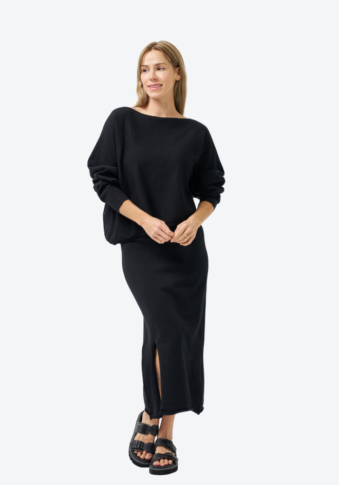 Woman wearing a black outfit on a white background