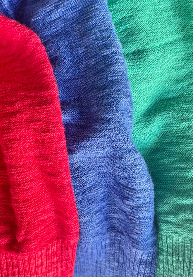 Close-up of red, blue, and green textured fabric swatches.
