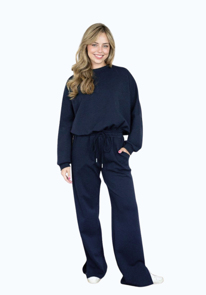 Woman wearing a navy blue outfit on a white background