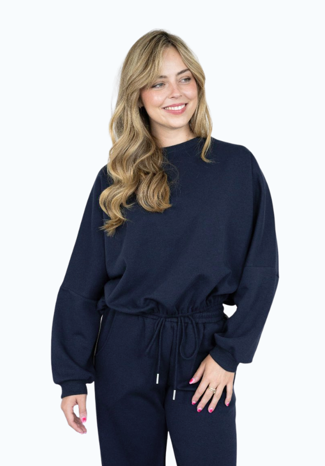 Woman wearing a navy blue outfit on a white background