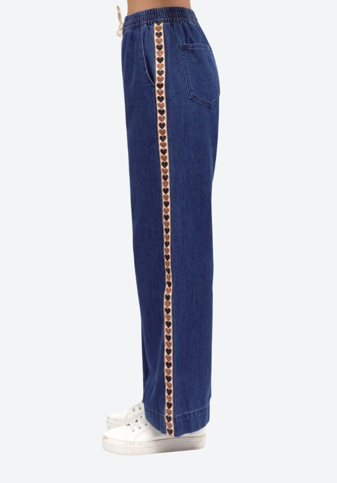 Blue pants with a decorative chain on a white background