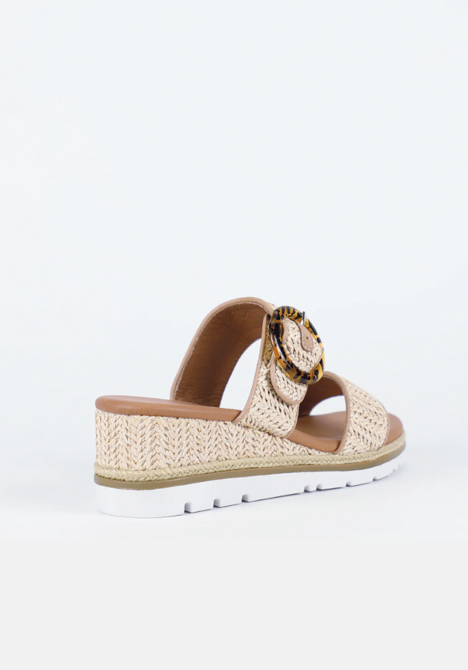 Woven sandal with a leopard print strap on a white background