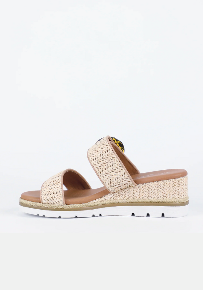 Beige sandal with woven design on a white background