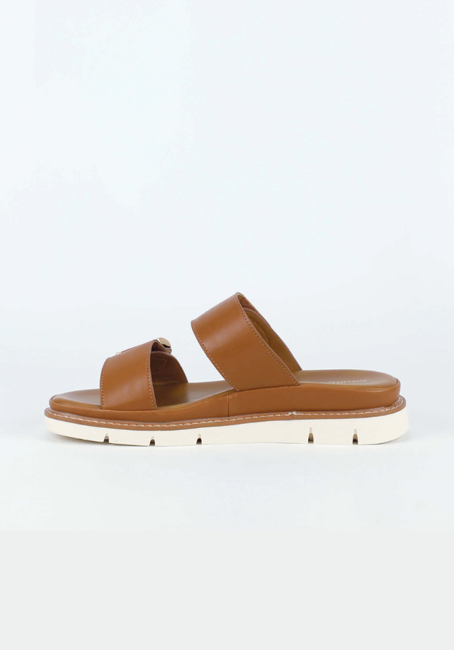 Brown sandal with gold accents on a light gray background