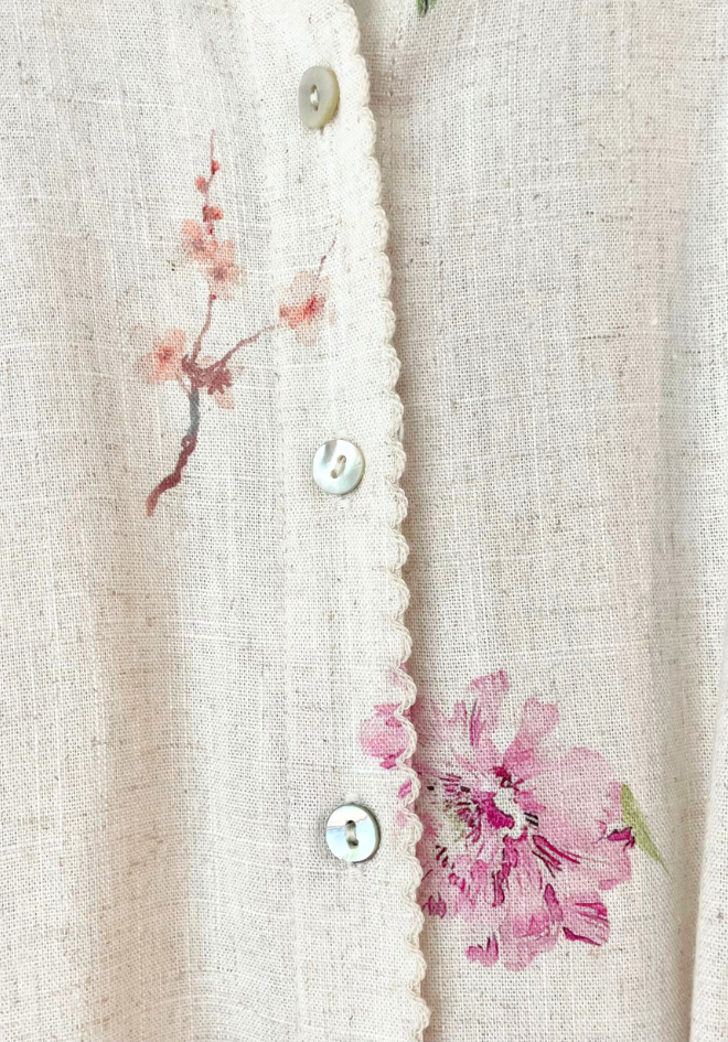 Close-up of a textured fabric with floral embroidery and buttons.