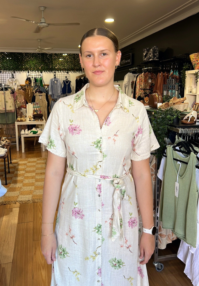 Woman wearing a floral dress in a clothing store