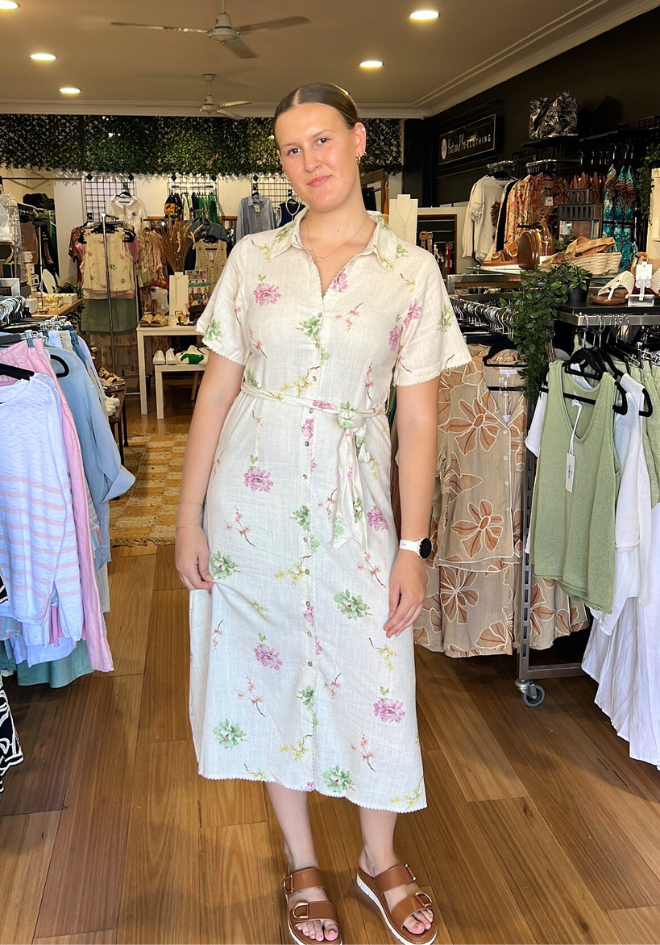 Woman wearing a floral dress in a clothing store