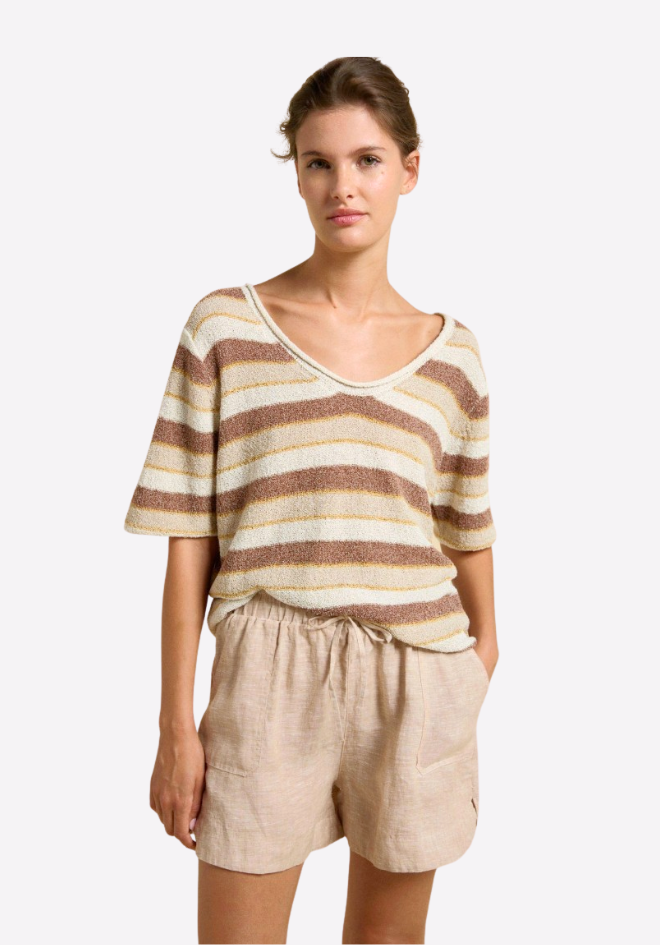 Woman wearing a striped top and shorts on a white background