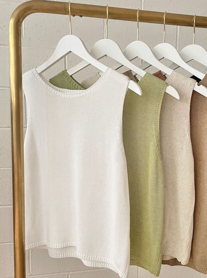 Little Lies Spring Tank White — white knit tank hanging on gold rack alongside sage, natural and tan colourways, shop in Australia at Kat and Ko Clothing
