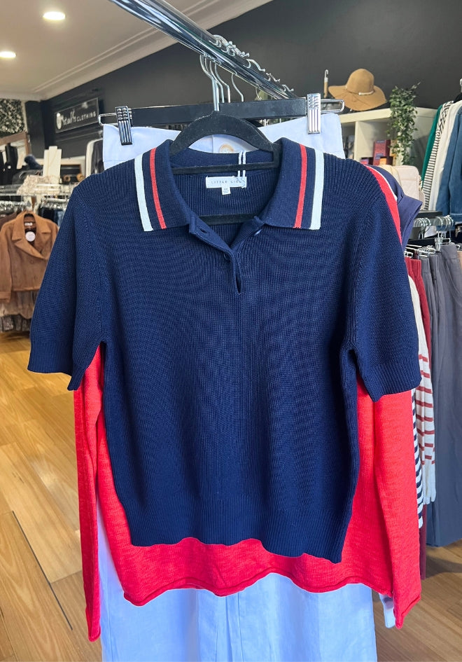 Little Lies Sailor Knitted Top Navy — navy ribbed knit polo top with red and white stripe collar and button placket, hanging in Kat and Ko Clothing boutique, shop in Australia at Kat and Ko Clothing