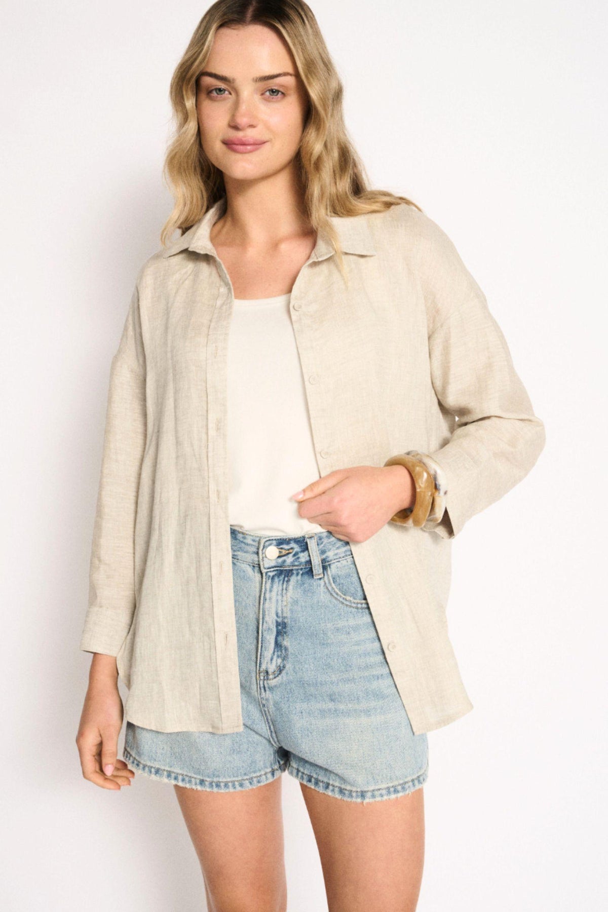 Little Lies Boyfriend Shirt in Natural linen worn open over a white tank with light denim shorts