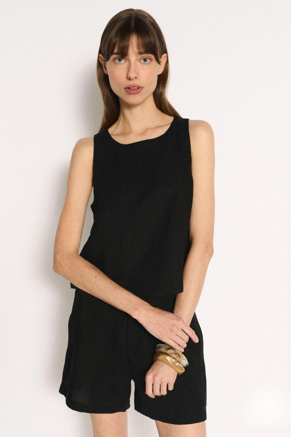 Little Lies Jude Shorts in Black front view, worn with a black sleeveless top and gold bangles