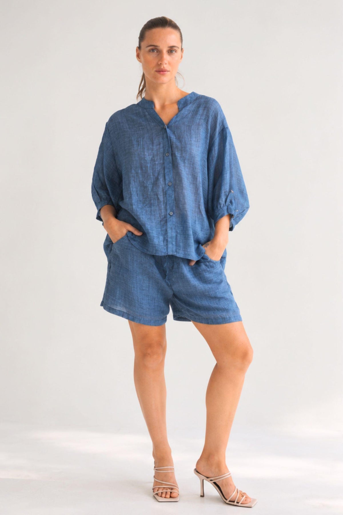 Worthier Aurora Linen Top and Eden Linen Shorts in Denim Blue worn as a set, full-length front view
