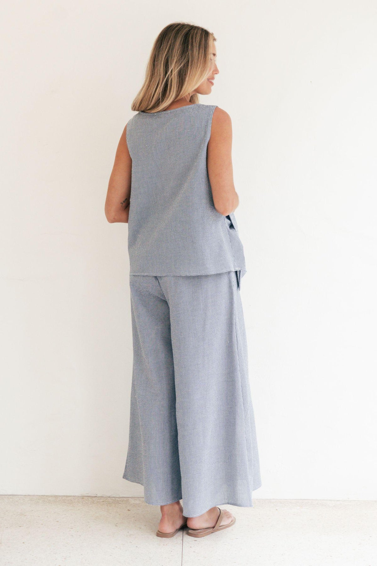 Label of Love Tie Front Check Top and Wide Leg Check Pant in Navy matching set, full-length back view