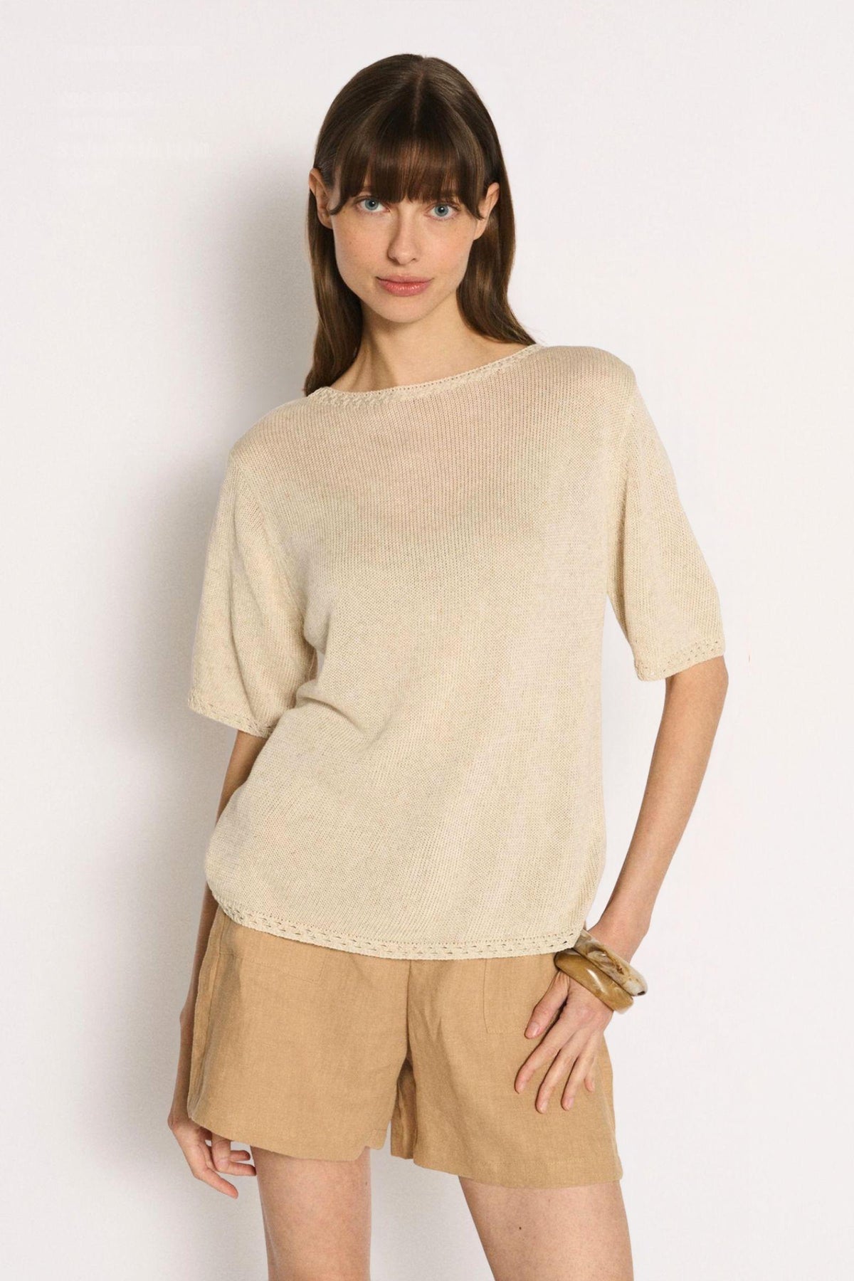 Little Lies Olivia Trim Tee in Natural straight-on front view showing the short sleeves, with tan shorts