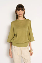 Little Lies Cassie Knit Top in Sage front view showing the wide round neckline and elbow-length sleeves, with cream pants
