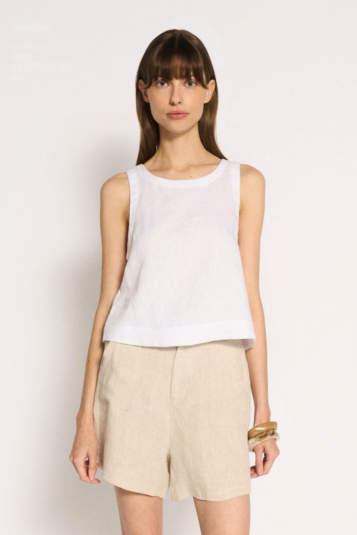 Little Lies Jude Shorts in Natural front view, worn with a white sleeveless top and gold bangle