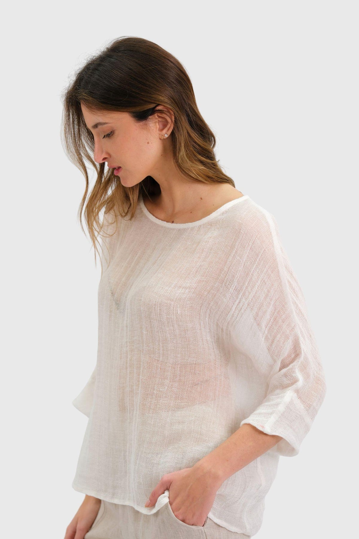 Nola Italian Linen Top - White by Worthier — angled close-up of the loose linen top and sleeve, styled with light trousers in Australia at Kat and Ko Clothing.
