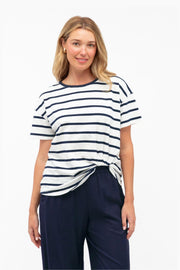 Easy Tuck Tee by Label of Love — front view of the navy and white striped short-sleeve tee with a tucked-look hem, styled with navy trousers, available in Australia at Kat and Ko Clothing