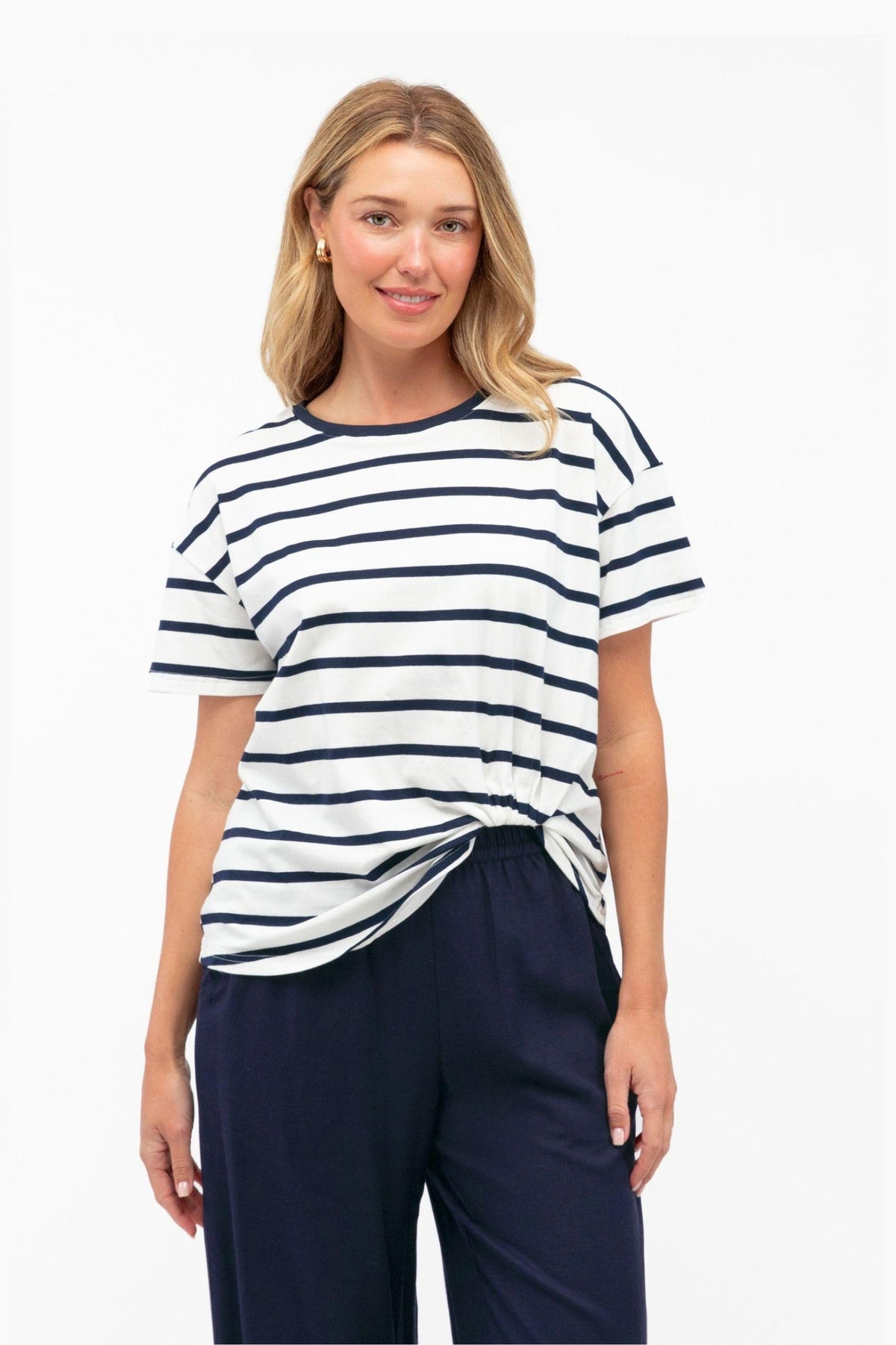 Easy Tuck Tee by Label of Love — front view of the navy and white striped short-sleeve tee with a tucked-look hem, styled with navy trousers, available in Australia at Kat and Ko Clothing