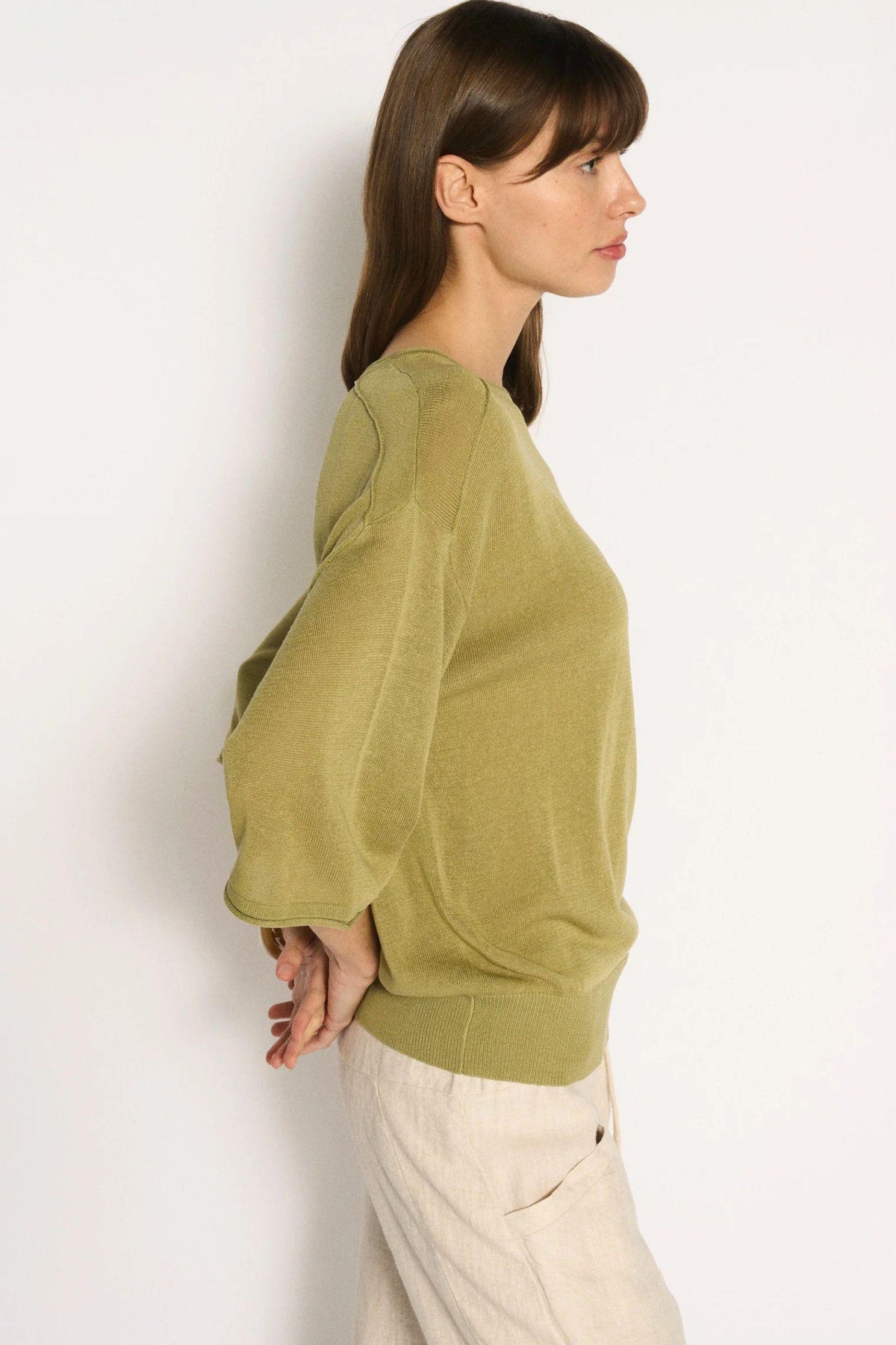 Little Lies Cassie Knit Top in Sage side profile showing the dropped shoulder and wide ribbed hem