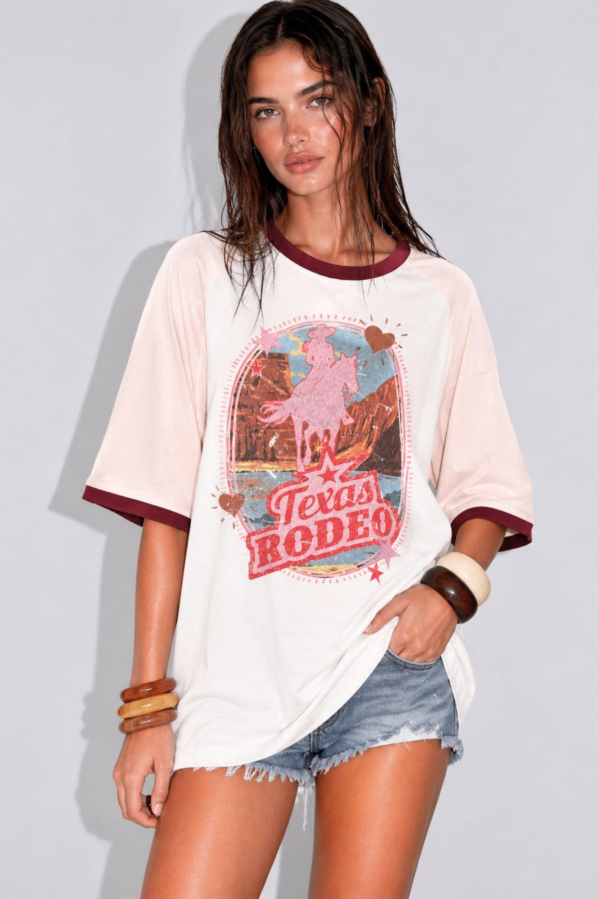 Texas Rodeo Tee by Coco Cartel — front view of the white oversized graphic tee with pink sleeve trim, styled with denim shorts, available in Australia at Kat and Ko Clothing