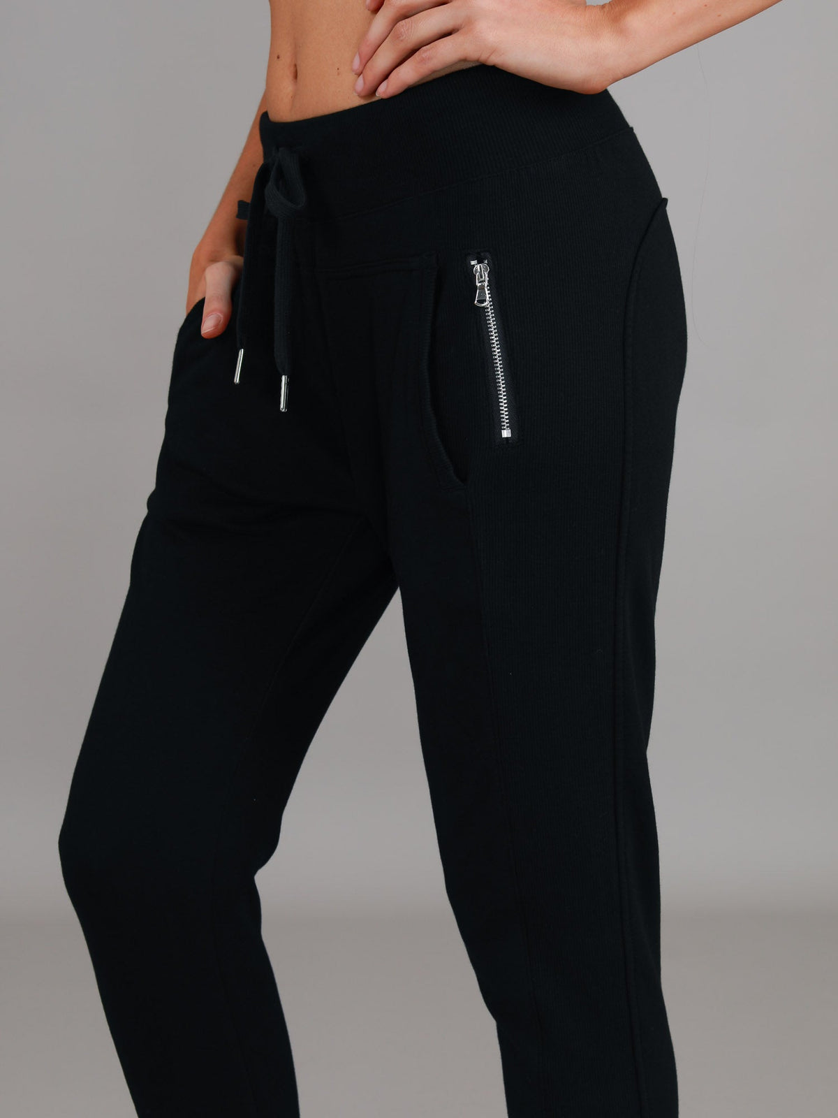 Byron Jogger Black 3rd Story The Label — cropped angled side shot highlighting the silver zip pocket and relaxed tapered fit of the black French Terry jogger, available in Australia at Kat and Ko Clothing