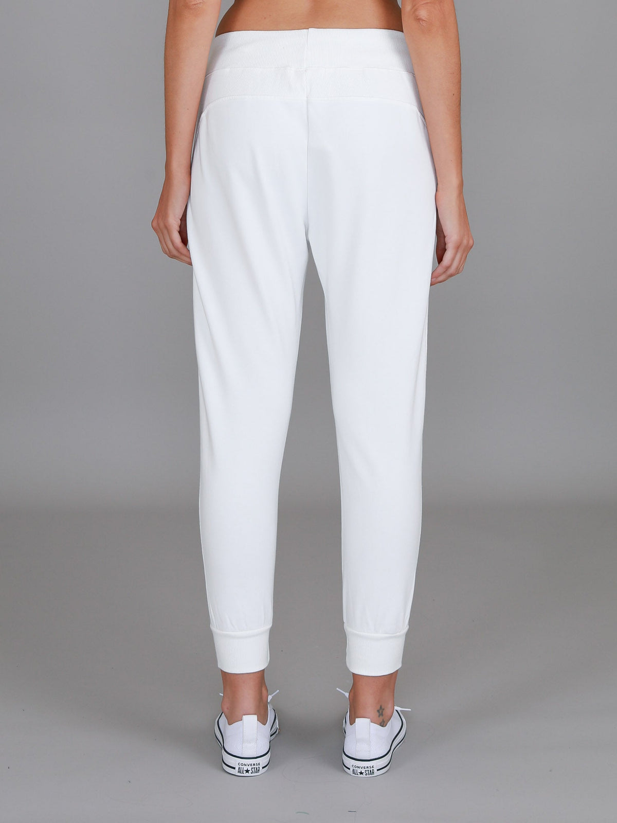 Byron Jogger in White by 3rd Story The Label — back full-length view of white French Terry jogger with elasticated cuffs, styled with white Converse sneakers, shop in Australia at Kat and Ko Clothing