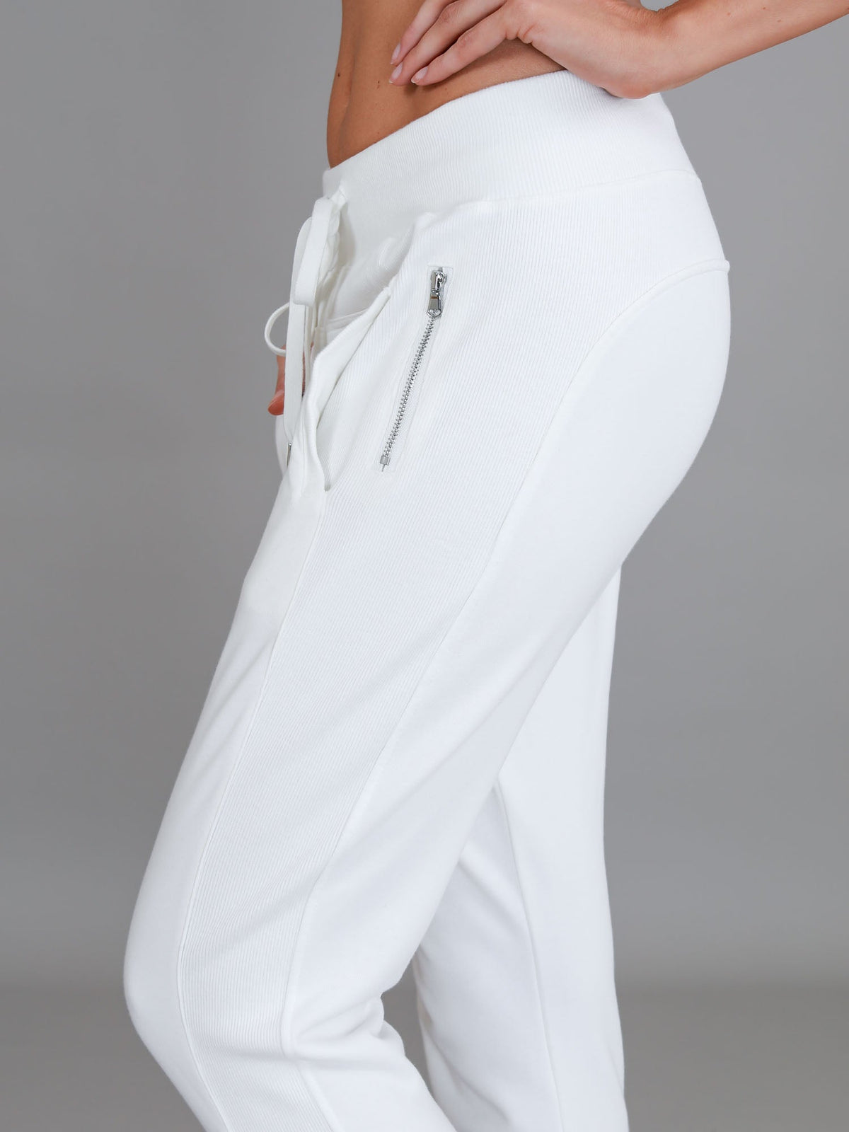 Byron Jogger White 3rd Story The Label — cropped angled side shot highlighting the silver zip pocket and relaxed tapered fit of the white French Terry jogger, available in Australia at Kat and Ko Clothing