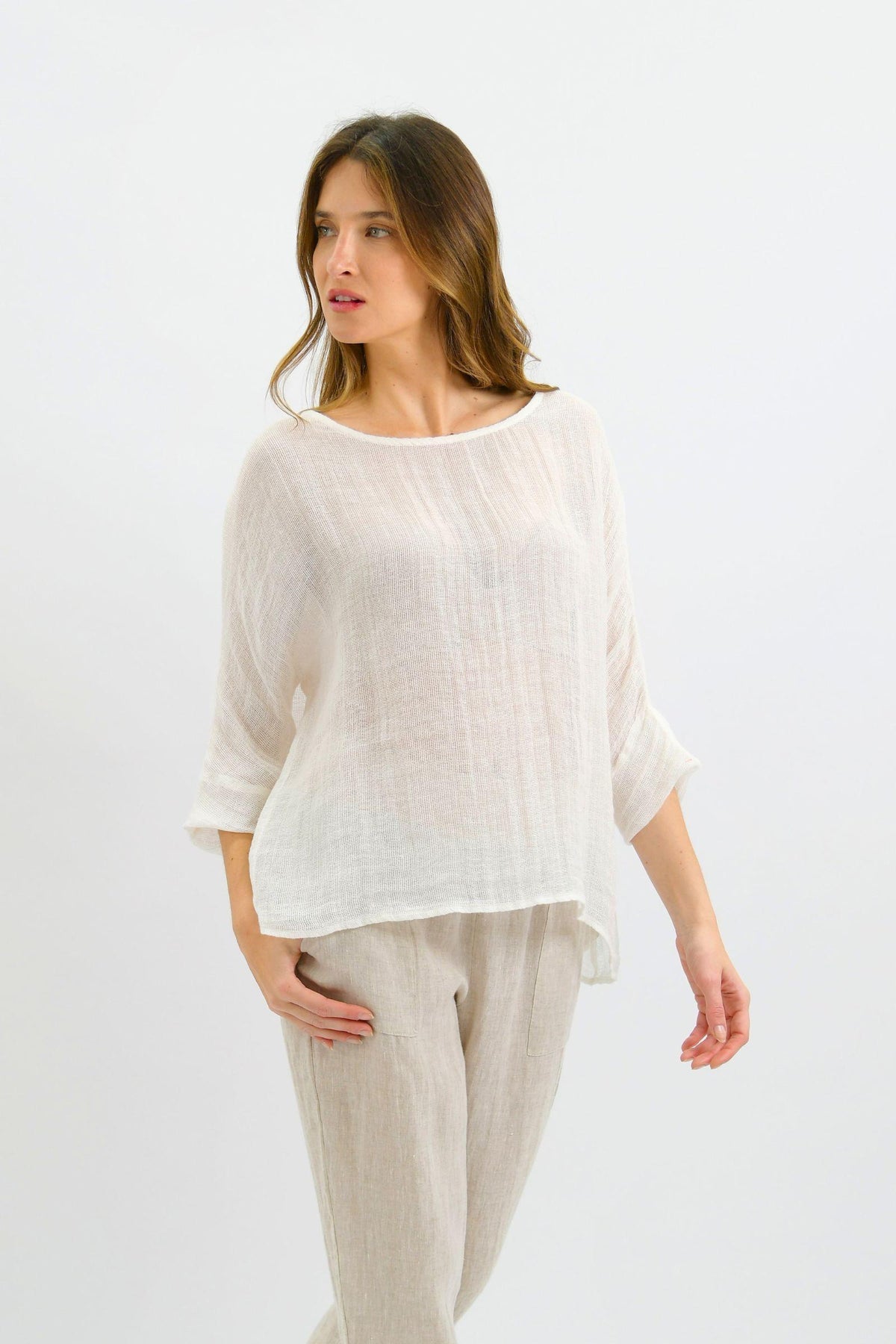 Nola Italian Linen Top - White by Worthier — angled front view of the relaxed white top with three-quarter sleeves, styled with light trousers in Australia at Kat and Ko Clothing.