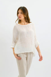Nola Italian Linen Top - White by Worthier — angled front view of the relaxed white top with three-quarter sleeves, styled with light trousers in Australia at Kat and Ko Clothing.