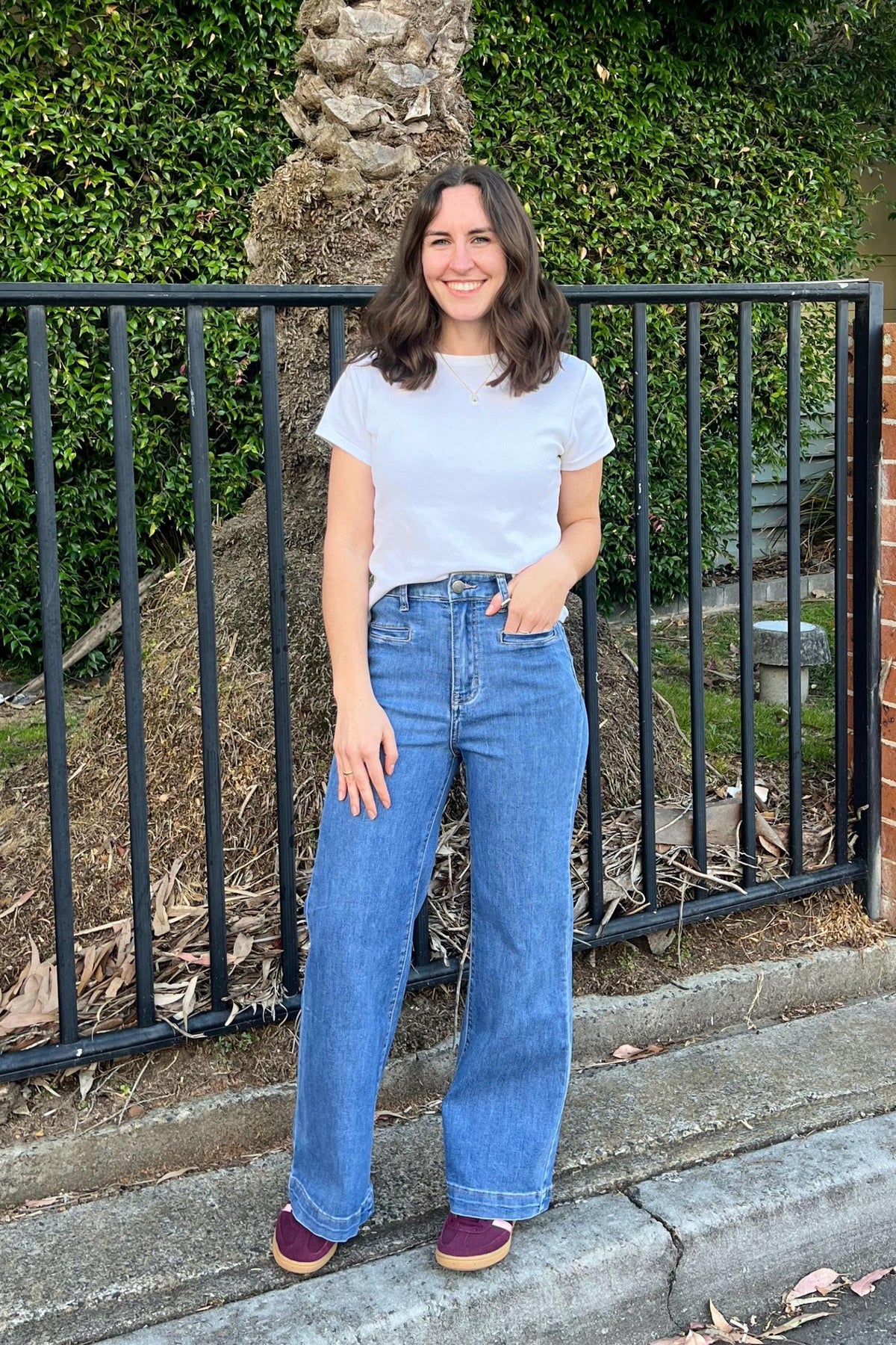 Derby Jeans in Light Denim by Wakee Jeans — lifestyle front view of wide-leg light wash denim jeans with high waist and front pockets, styled with a white classic tee and burgundy suede sneakers, shop in Australia at Kat and Ko Clothing