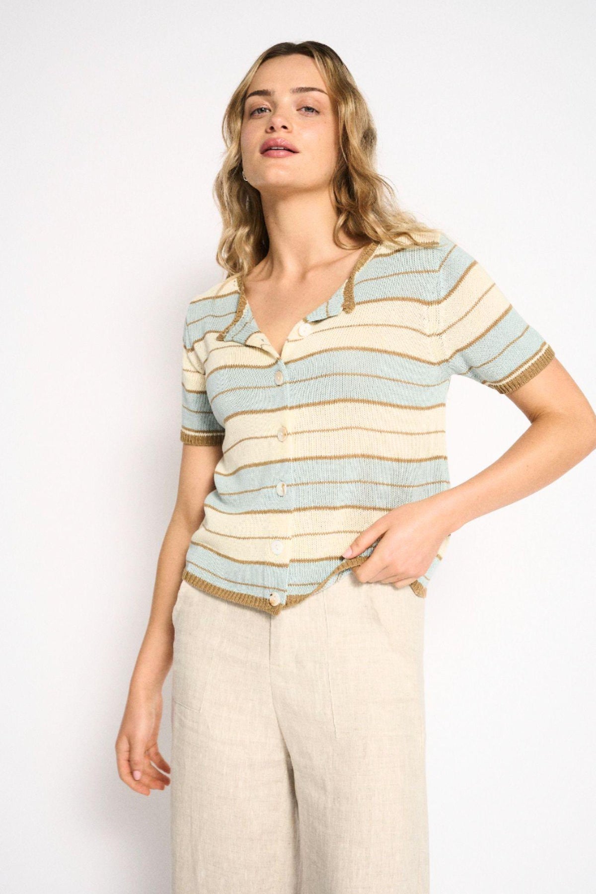 Solene Stripe Button Top in Soft Aqua by Little Lies — three-quarter front view of soft aqua, cream and tan stripe short sleeve knit button-through top with collared neckline, styled with cream wide-leg linen trousers, shop in Australia at Kat and Ko Clothing