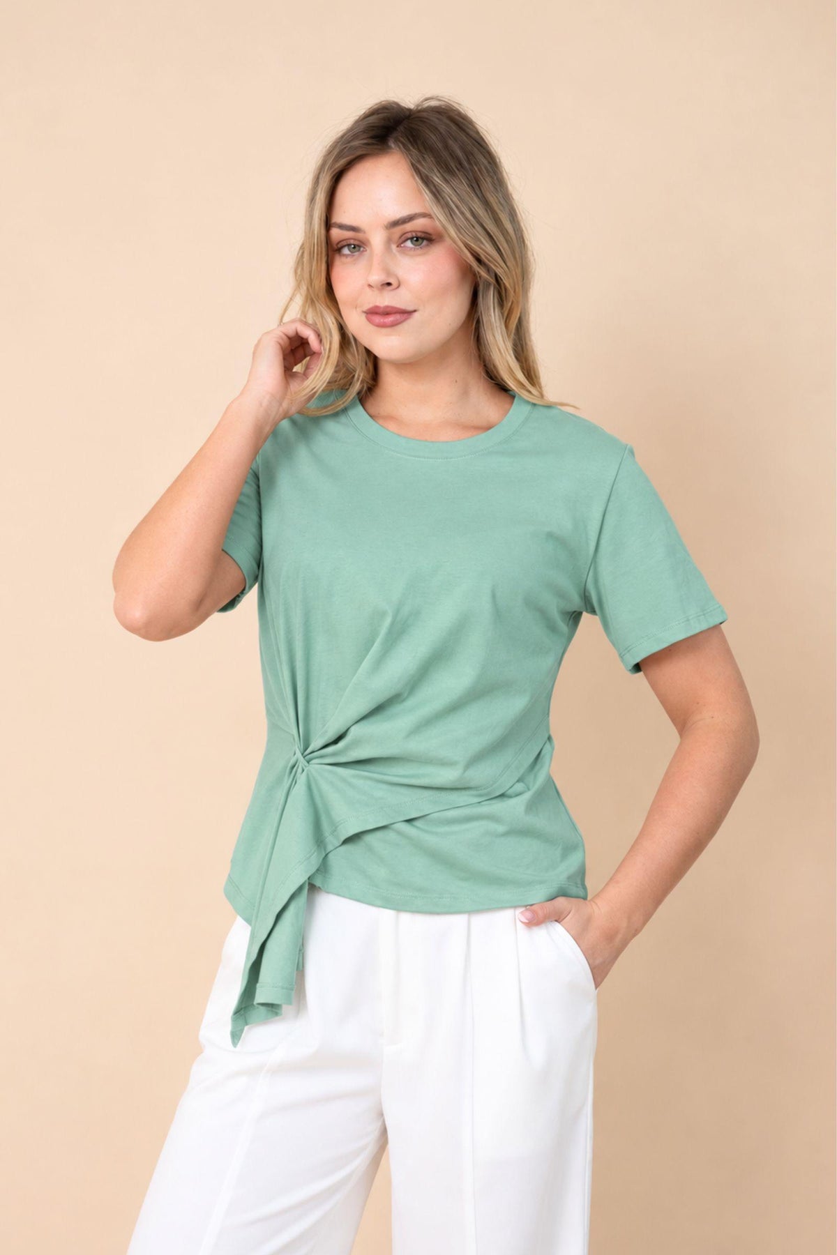 Fria The Label Ellery Ring Detail Tee in Mint front view showing the side ring detail, worn with white pants