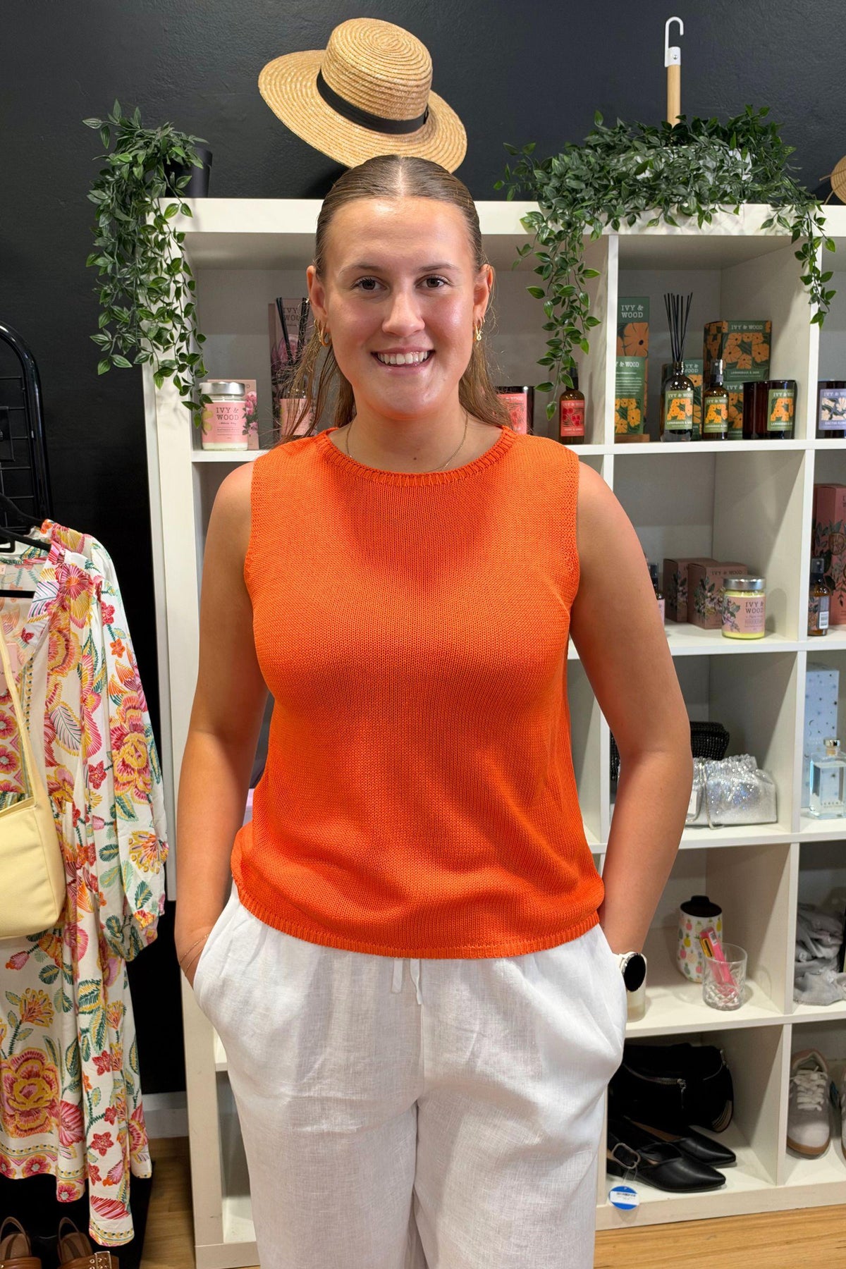 Little Lies Spring Tank in Vivid Orange front view showing the textured knit, worn with white pants