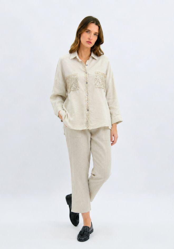 Worthier Lumina Sequin Linen Shirt — full-length front view of relaxed natural linen shirt with sequin pocket embellishment and long sleeves, styled as a matching set with linen trousers and black loafers, shop in Australia at Kat and Ko Clothing