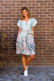 Sanders Dress by Boho Australia — full-length front view of the sage floral dress with collar neckline, button front, tulip sleeves and self-fabric belt, styled with white sneakers, available in Australia at Kat and Ko Clothing