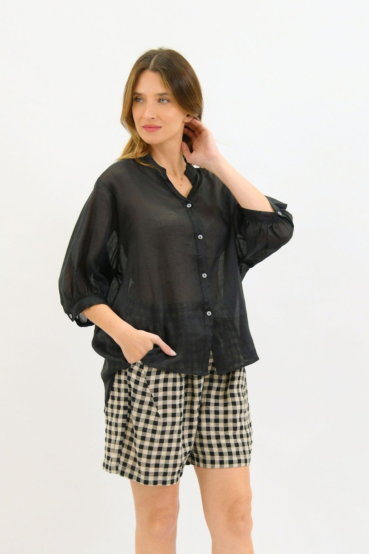 Aurora Linen Top - Black by Worthier — front view showing the button-up top and relaxed sleeves, styled with checked shorts in Australia at Kat and Ko Clothing.