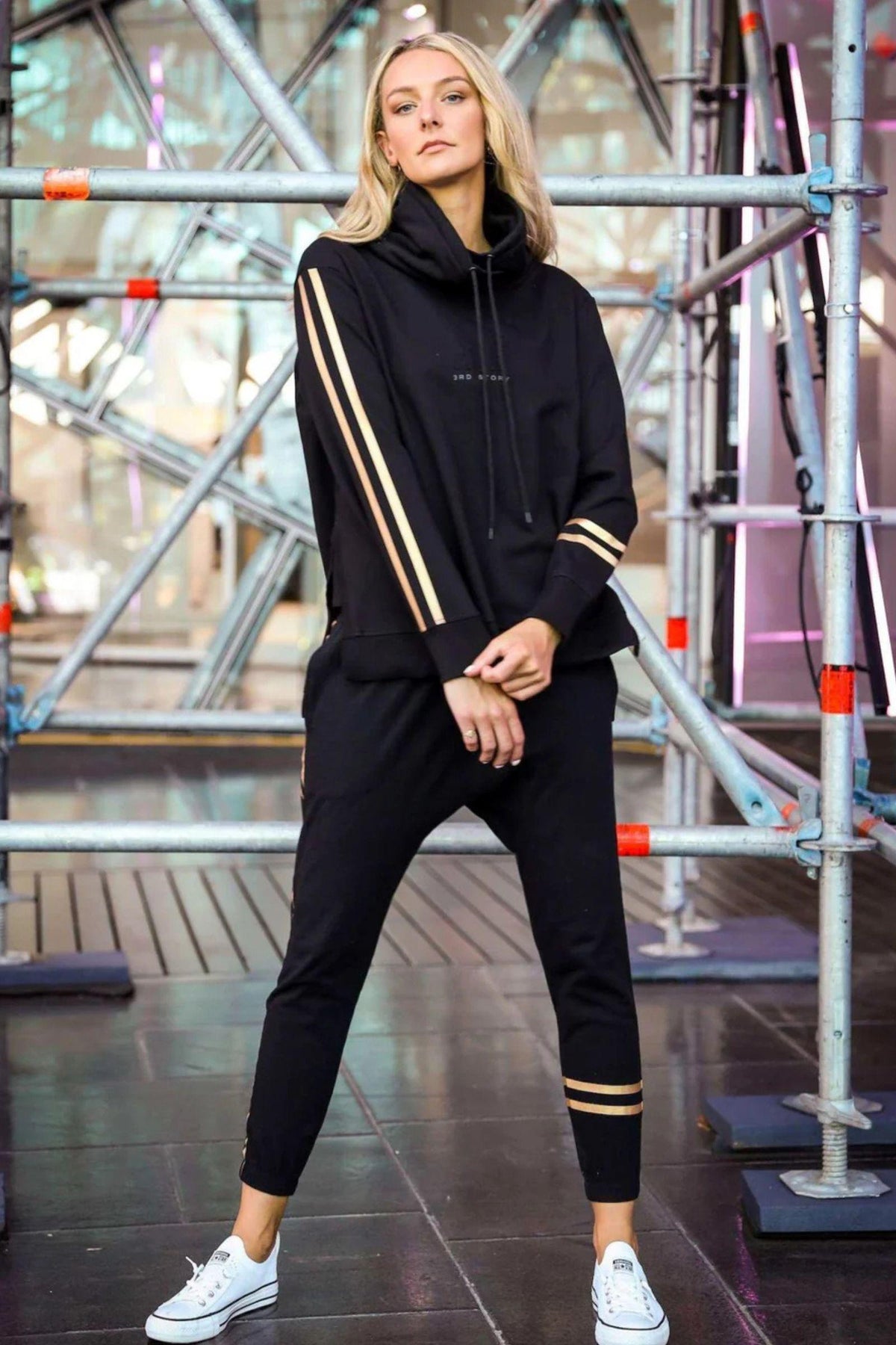 Darcy Golden Stripe Funnel Neck Sweater - Black, lifestyle shot with wide stance pose