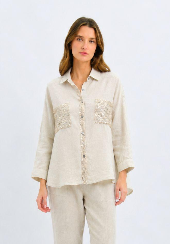 Lumina Sequin Linen Shirt by Worthier — cropped front view of natural linen button-up shirt with sequin embellished chest pockets and sequin button placket, styled with matching linen trousers, available in Australia at Kat and Ko Clothing