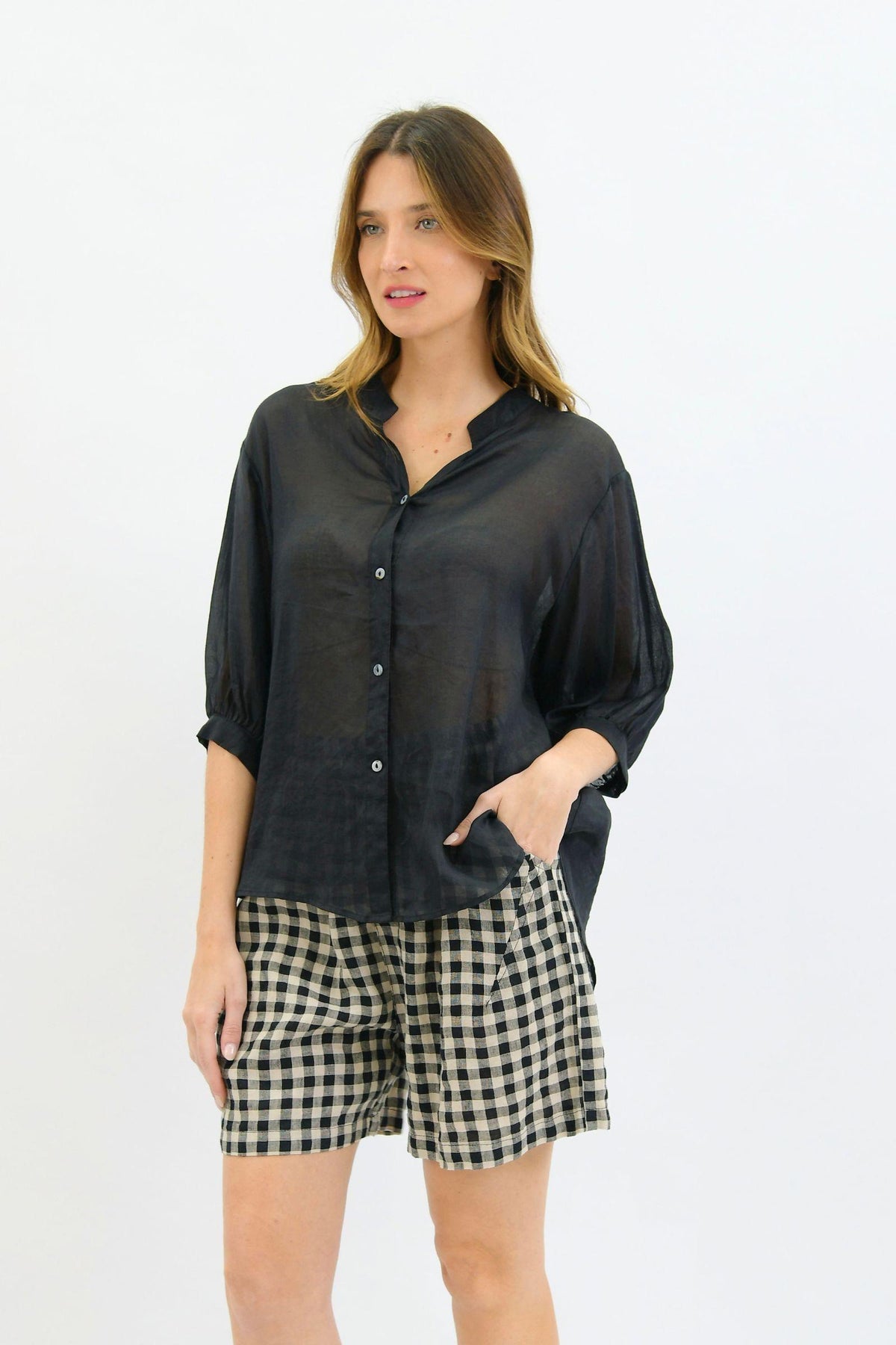 Worthier Aurora Linen Top - Black — full-length front view of the loose black linen top, styled with checked shorts in Australia at Kat and Ko Clothing.