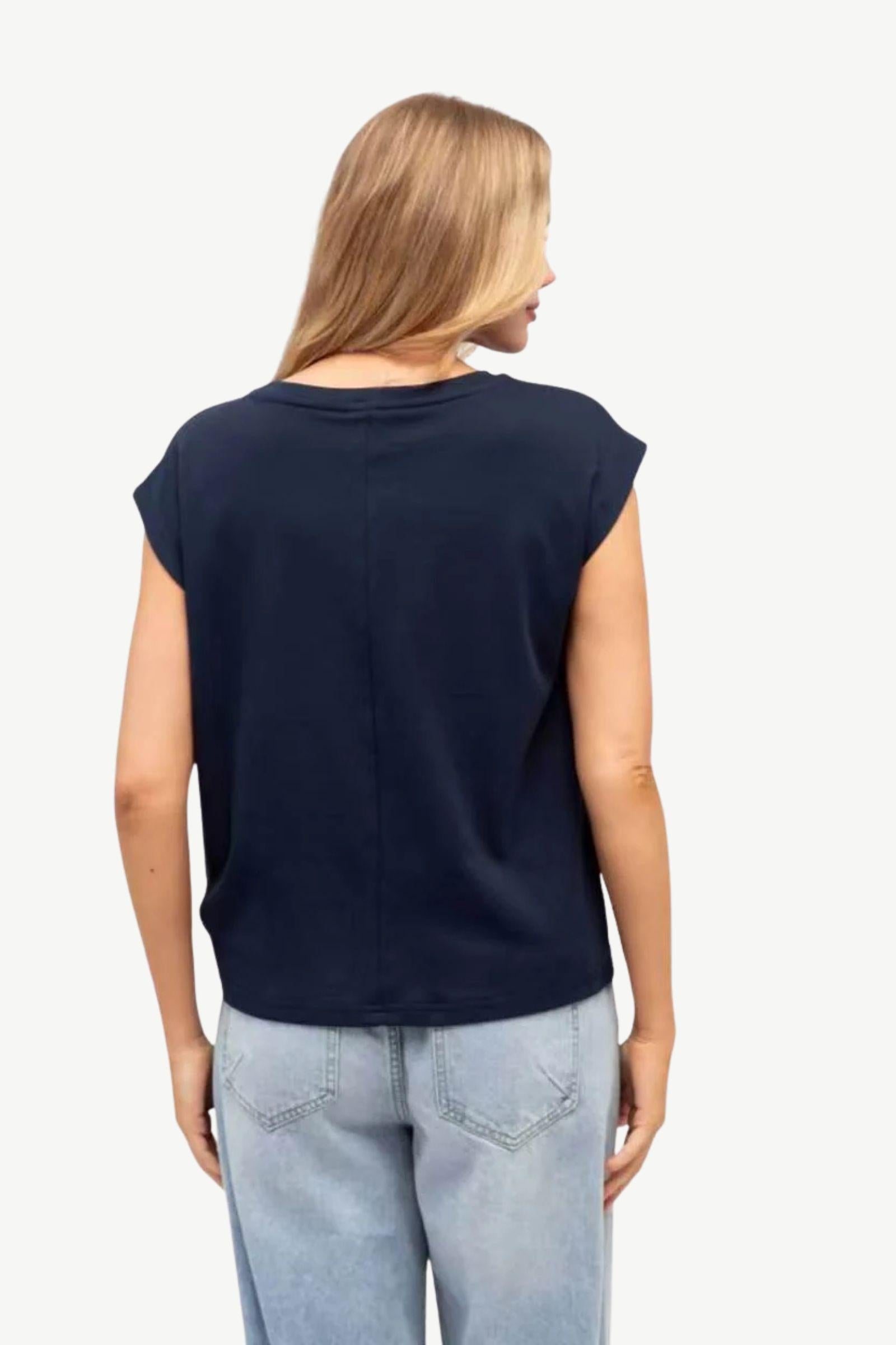 Cap Sleeve Tuck Tee Navy Label of Love — back view showing the clean lines of the navy cap sleeve tee with tuck hem detail, styled with light blue wide-leg jeans, shop in Australia at Kat and Ko Clothing