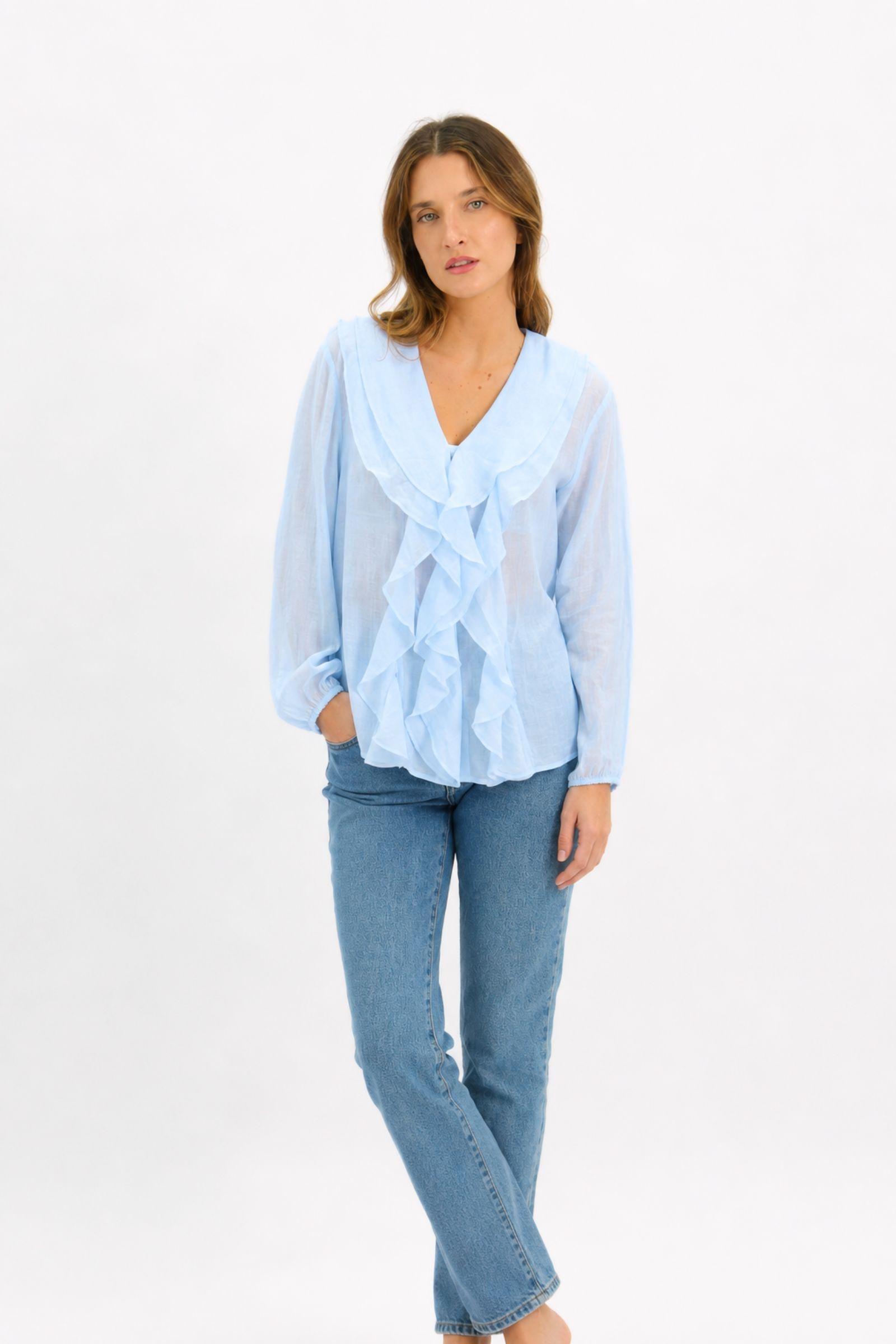 Worthier Claire Linen Blouse Ice Blue — full-length front view of the cascading frill linen blouse with long sleeves, styled with straight-leg blue jeans, shop in Australia at Kat and Ko Clothing