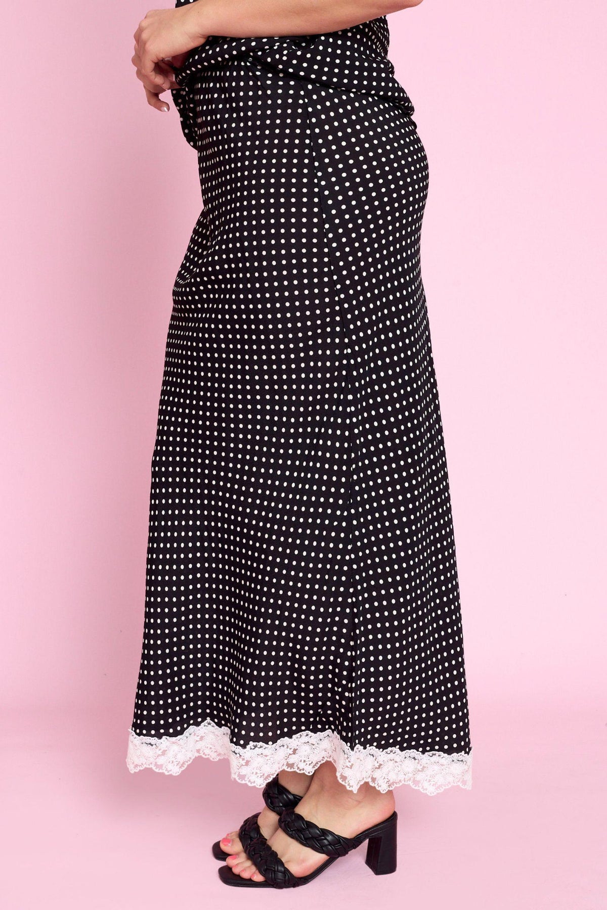 Fria The Label Vivienne Skirt in Black and White, side view of the polka dot maxi and lace hem